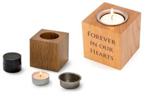 Eternity candle. Wooden block with tea light and small hidden container for ashes to be stored. Engraving reads "forever in our hearts".